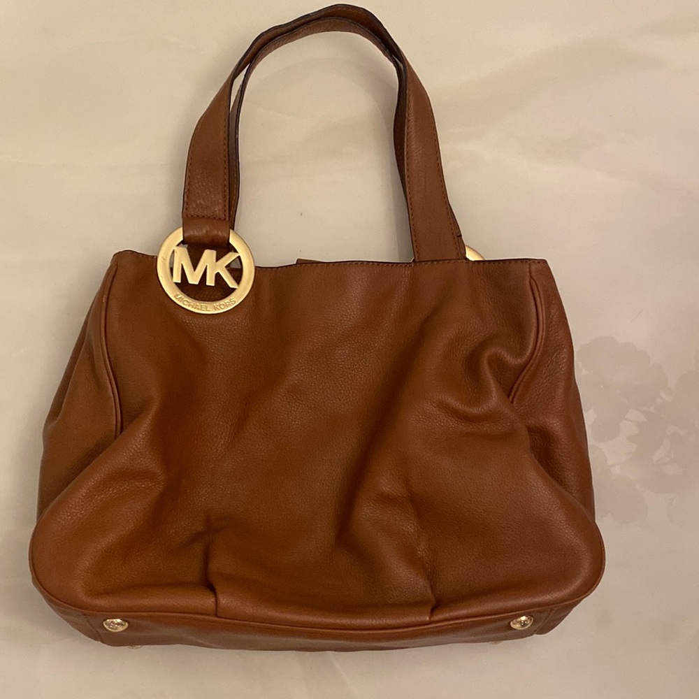 Michael Kors pebbled leather cognac satchel.